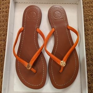 Orange Tory Burch flip flops